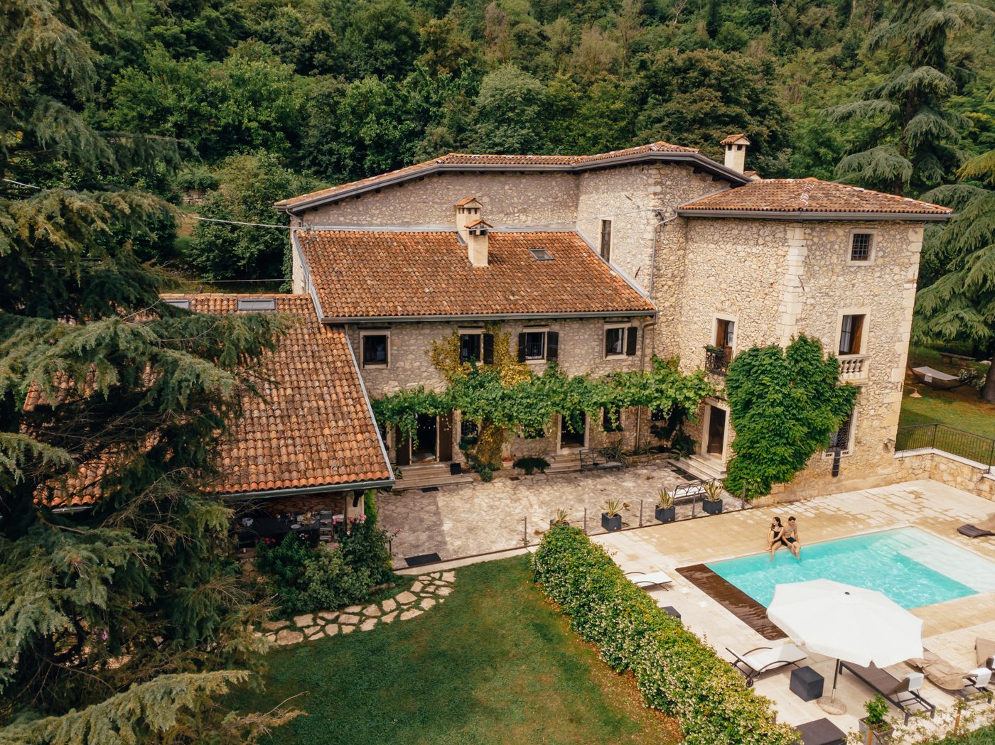 A stone villa with a pool on a wooded hillside in the South of France